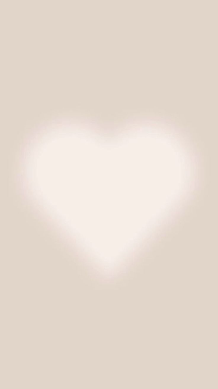 a white heart shaped object on a light gray background with the word love written below it