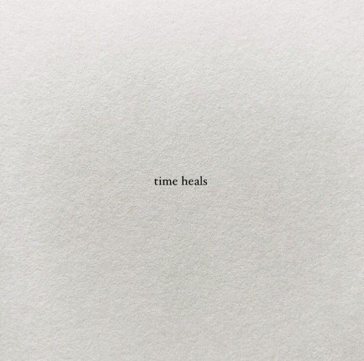 the word time heals written in white paper