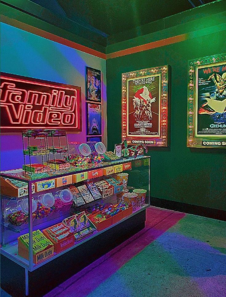 a brightly lit video game shop with neon signs on the wall and posters behind it