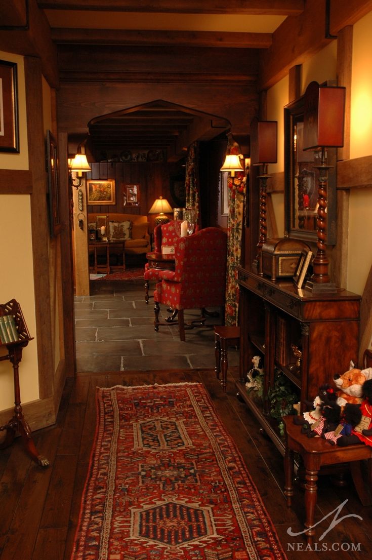 the hallway is decorated with antique furniture and decor