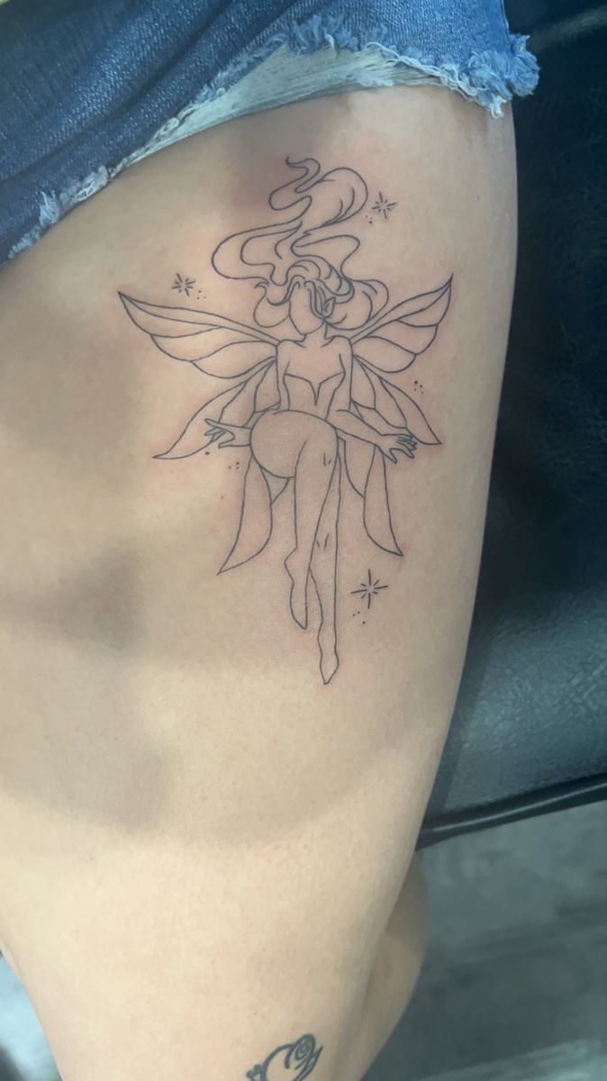 a woman's thigh with a fairy tattoo on it