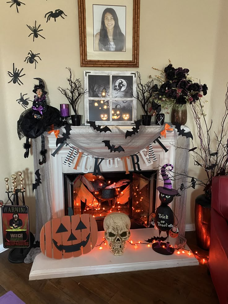 a fireplace decorated for halloween with decorations