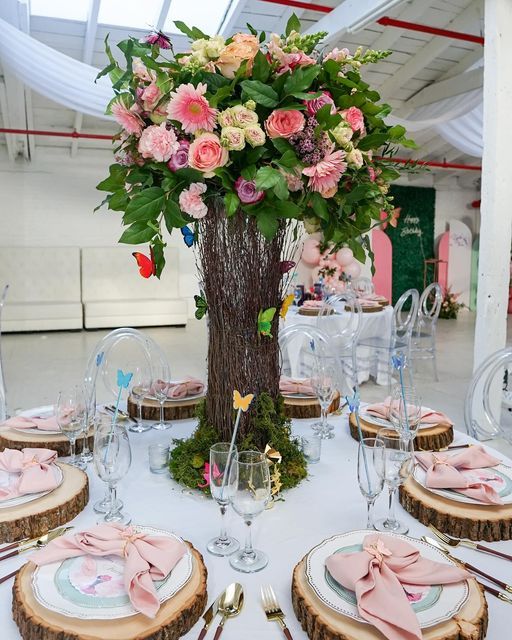 the table is set with plates and place settings