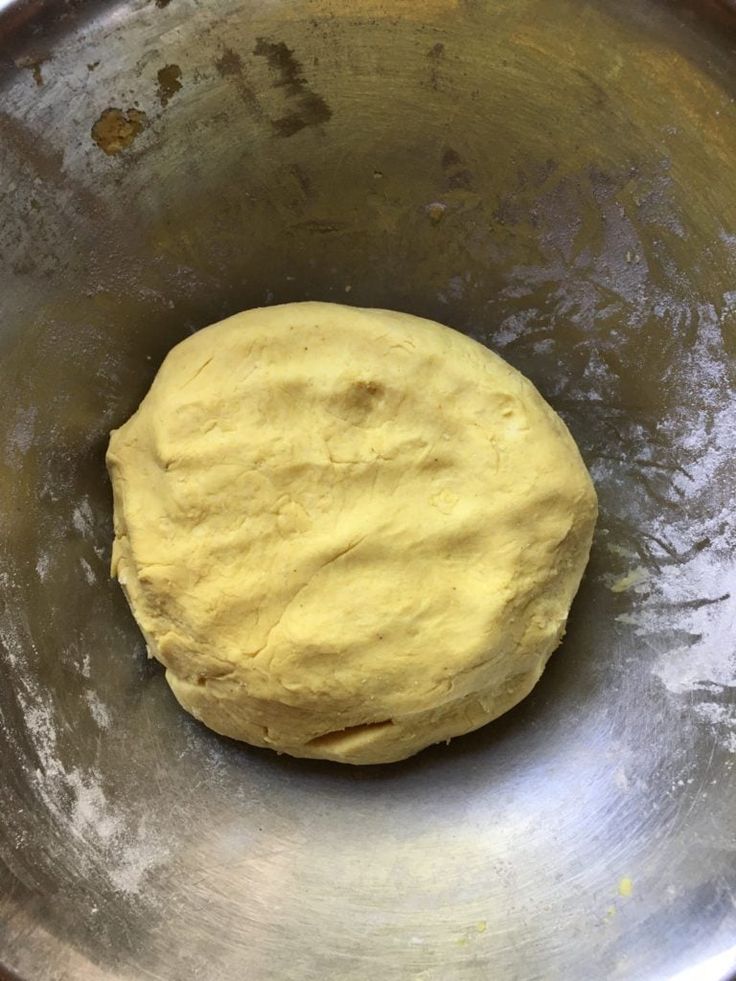 a ball of dough in a metal bowl