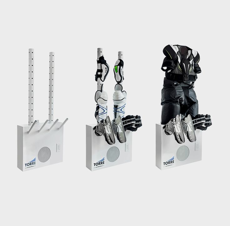 three robot sculptures sitting on top of each other in front of a white wall and floor