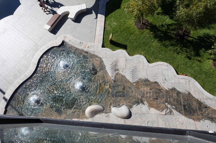 an aerial view of a fountain in the middle of a park