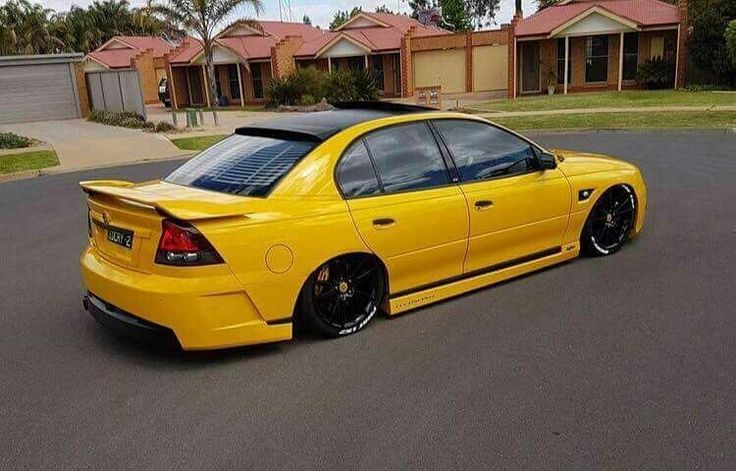 the yellow car is parked on the street