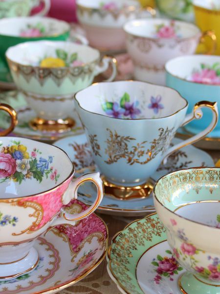 tea cups and saucers are sitting on a table