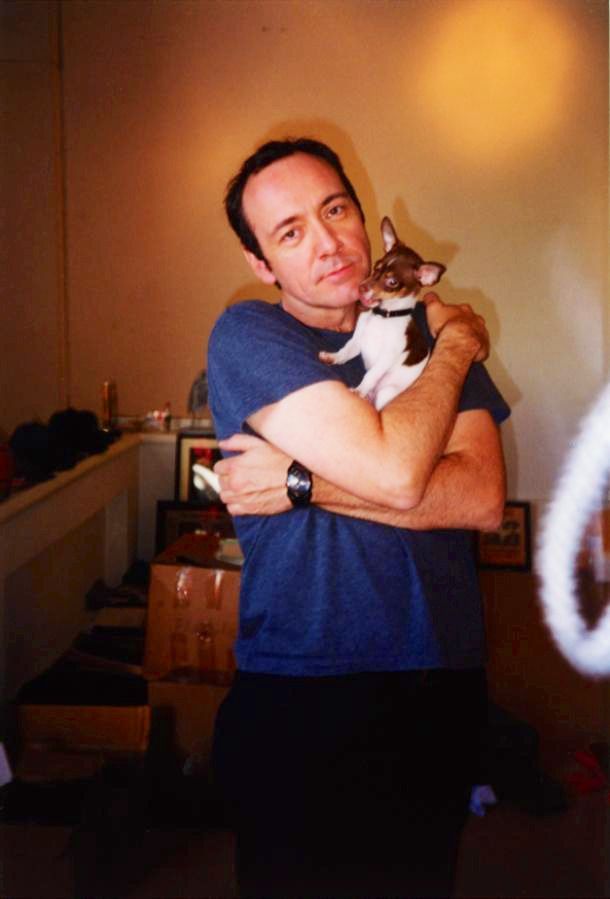 a man holding a cat in his arms