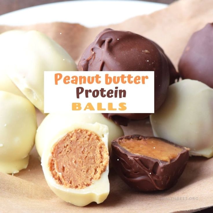 there are many different types of peanut butter balls on the paper plate with a sign that says, peanut butter protein balls