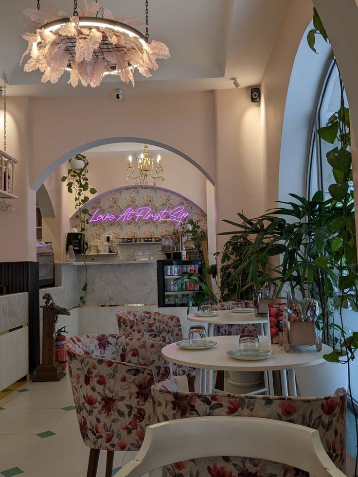 the inside of a restaurant with chairs and tables