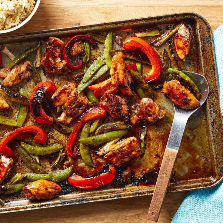 a pan filled with chicken, peppers and rice