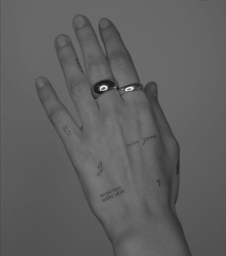 a person's hand with two rings on it