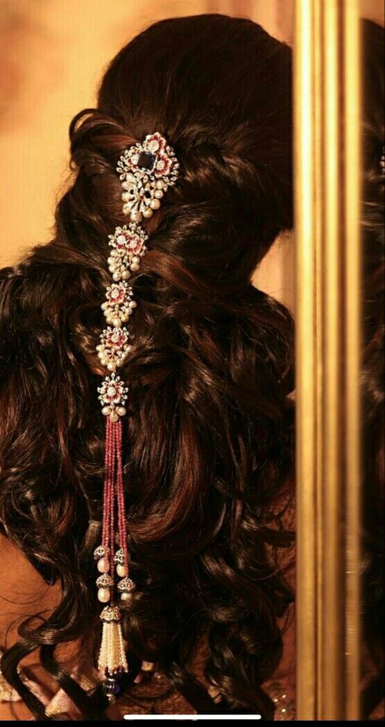 the back of a woman's head with hair combs and beads on it