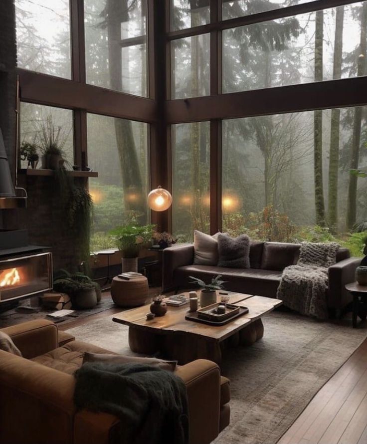 a living room filled with furniture and a fire place in the middle of a forest