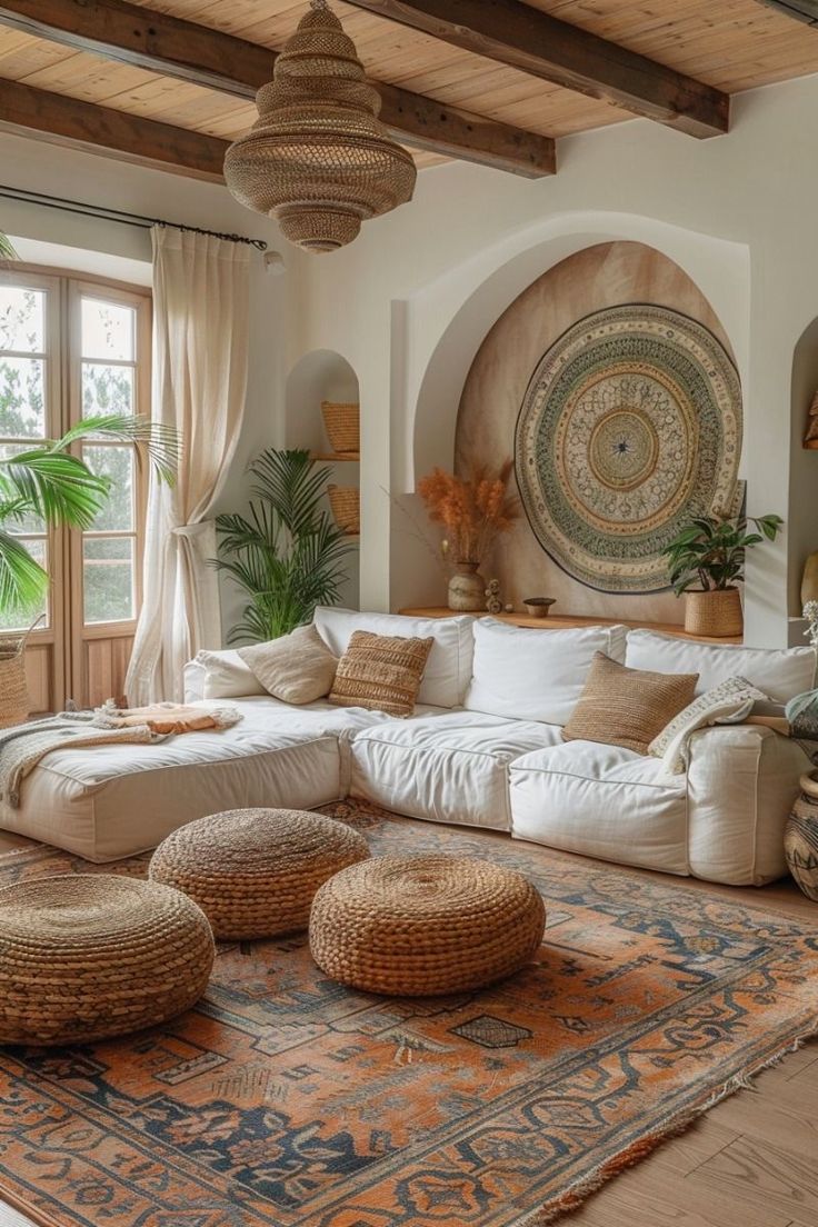 a living room filled with lots of furniture next to a large rug on the floor