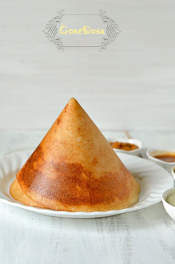 a white plate topped with a pastry covered in brown sugar next to bowls of dipping sauce