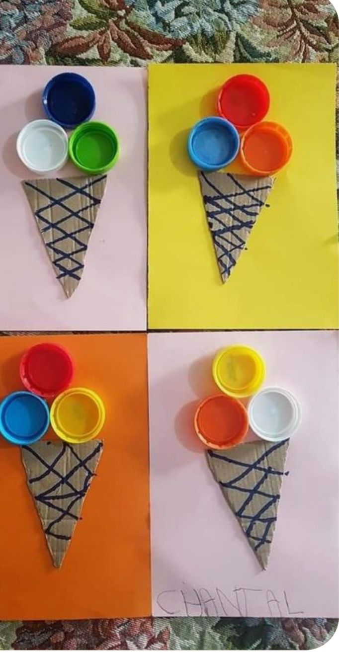 three ice cream cones with different colored bowls on them, and one cone is made out of paper