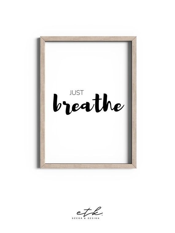 a framed poster with the words just breathe in black ink on it, against a white background