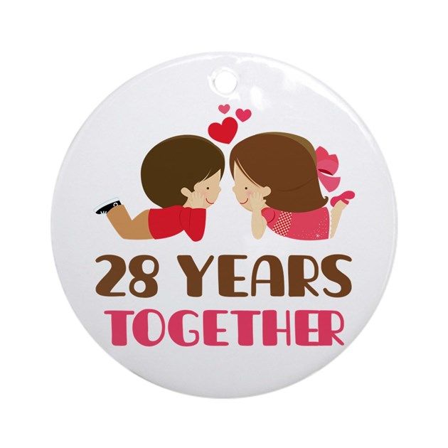 a round ornament that says 28 years together with two girls hugging each other