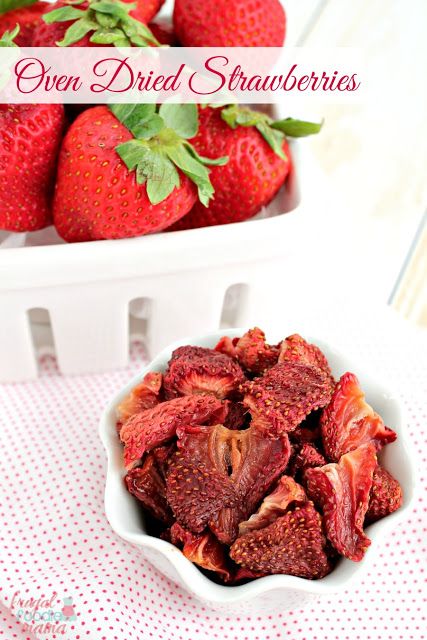 strawberries in a white bowl on a red and white checkered tablecloth with the words oven dried strawberries