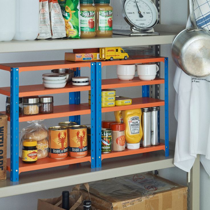 the shelves are filled with various food items and have blue metal brackets to hold them