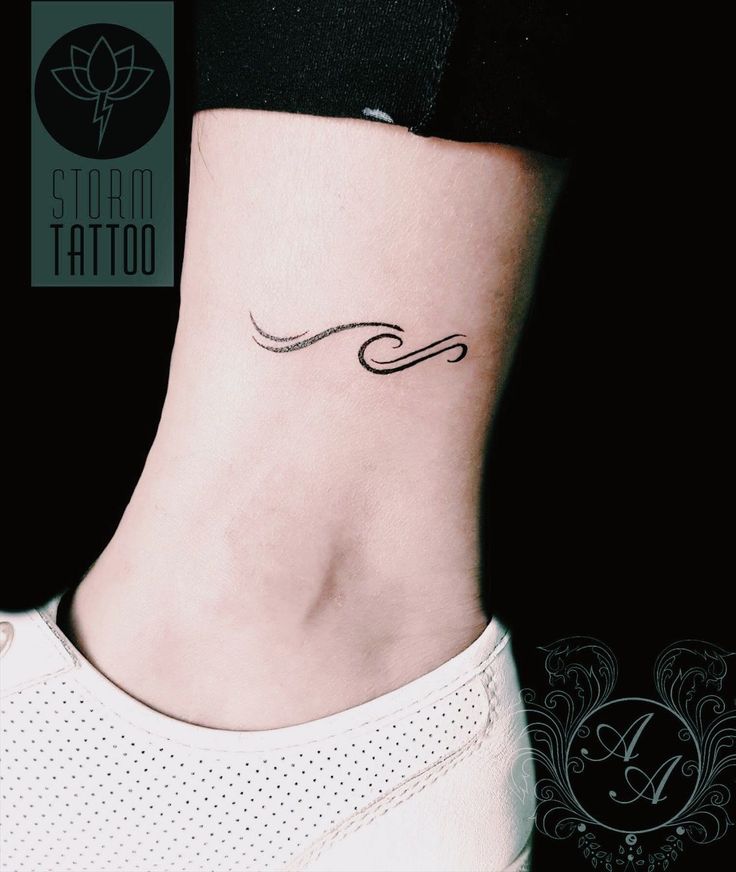 a woman's ankle with a small wave tattoo on her left side ribcage