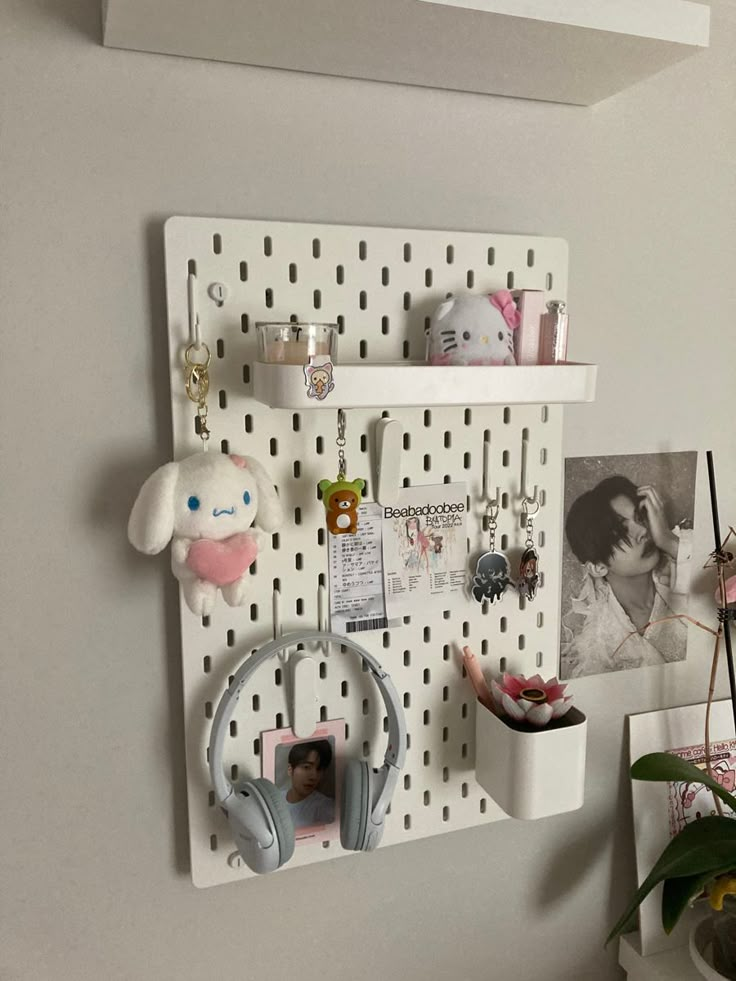 a white peg board with headphones hanging on it