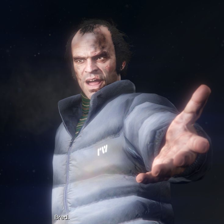 a man in a blue jacket pointing his finger at the camera with an evil look on his face