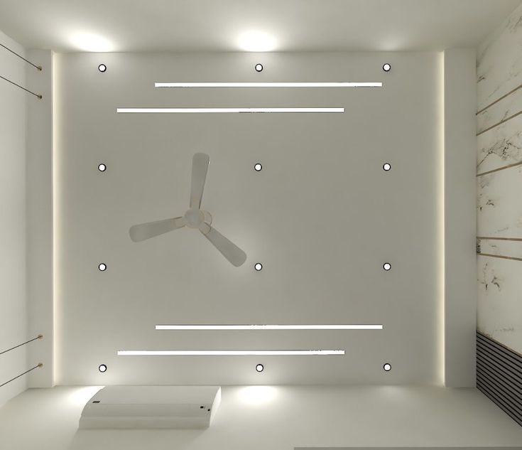 a ceiling fan in the middle of a room with white walls and lights on it