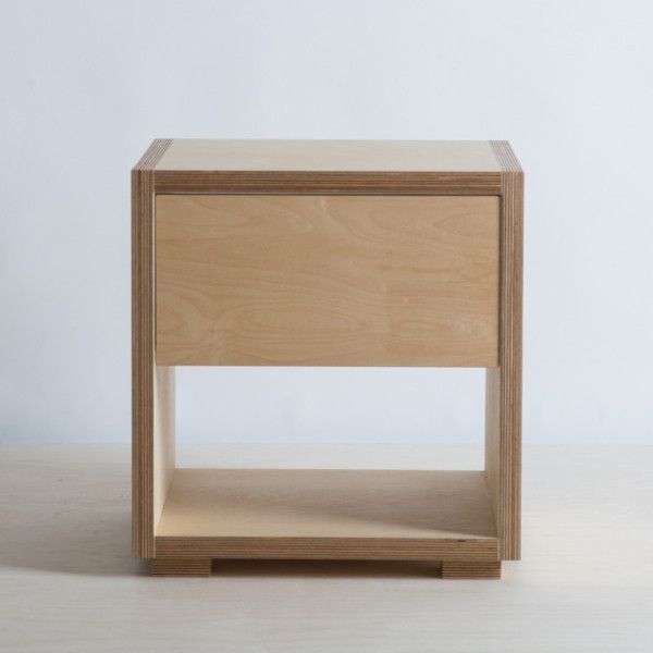 a small wooden table sitting on top of a white floor