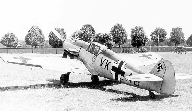 an old airplane sitting on top of a grass covered field