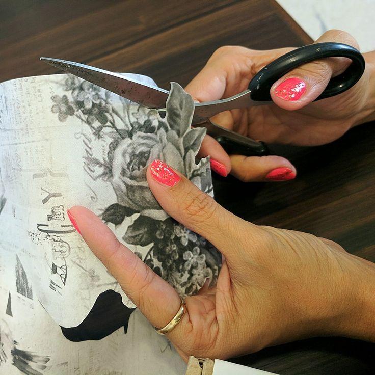 a woman is cutting fabric with scissors