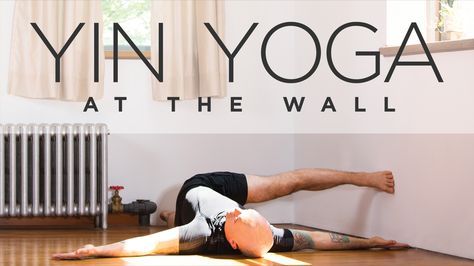 a man laying on the floor in front of a yoga mat with his legs spread out