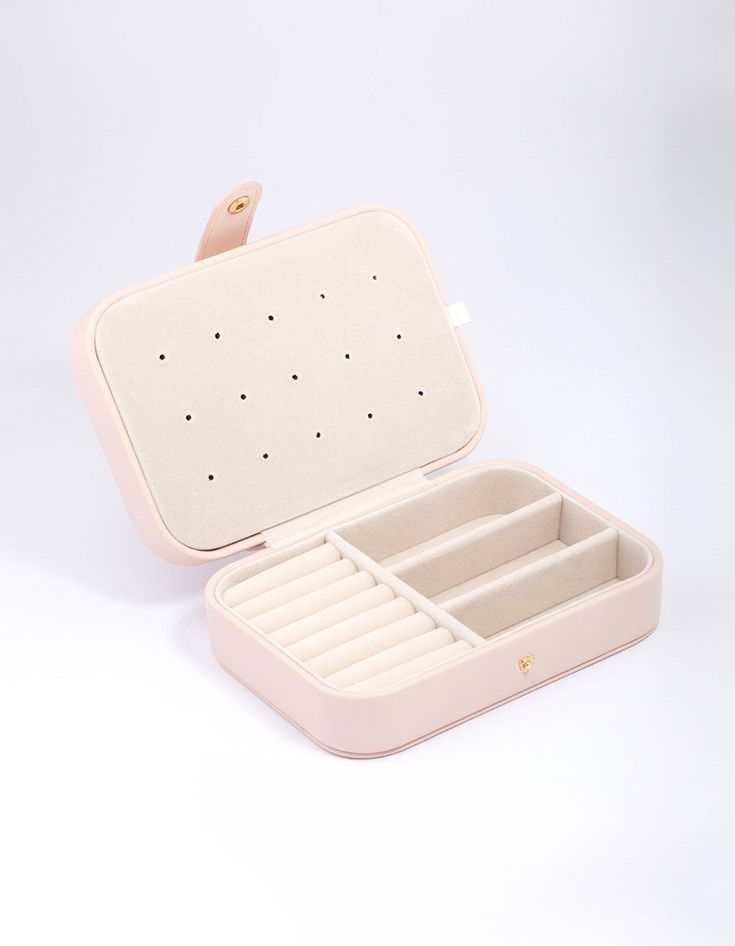 an open pink jewelry box on a white background