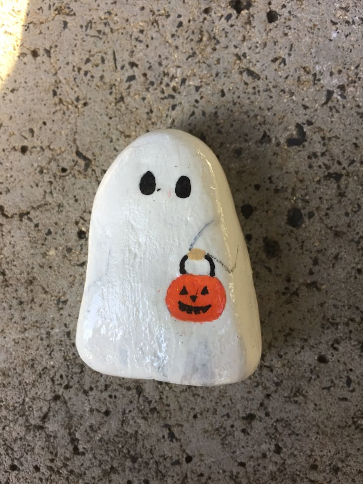 a rock with a ghost painted on it