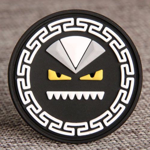 a black and white badge with yellow eyes