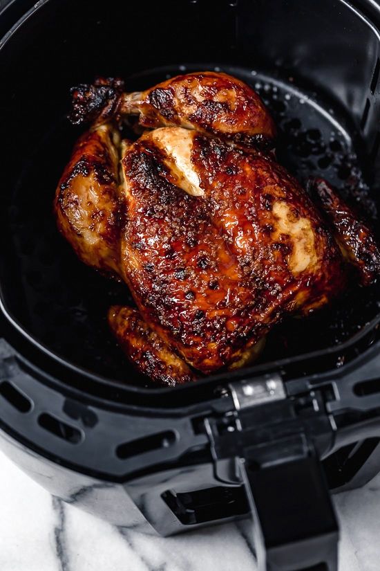 a close up of a chicken in an air fryer