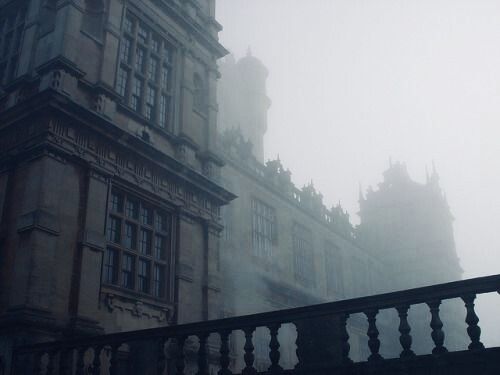 an old building is shown in the fog