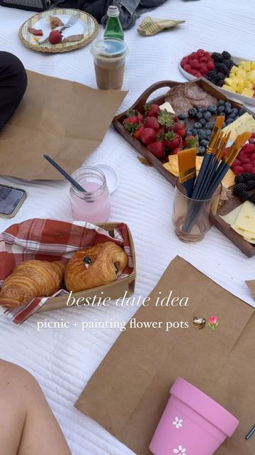 people are sitting at a table with food and drinks on it, including croissants