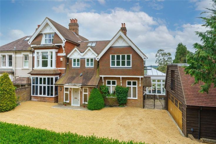 a large brown house with white trim and windows