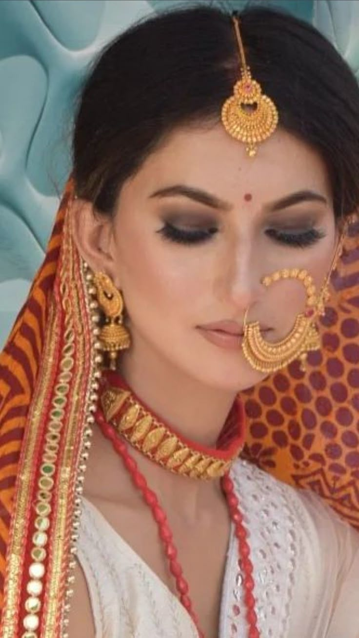 a woman wearing an elaborate head piece and jewelry