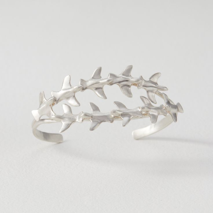 Silver Bracelet - This cast sterling silver cuff is a marvelous statement piece, displaying two charming rows of flying birds, each row flying in the opposite direction. Combining a playful, organic theme with upscale metals, its the perfect piece to add a bit of fun to any ensemble. Flying Birds, Jewelry Artist, Artful Home, Birds Flying, Sterling Silver Cuff, Artistic Jewelry, Silver Cuff, Silver Bracelets, Precious Metals