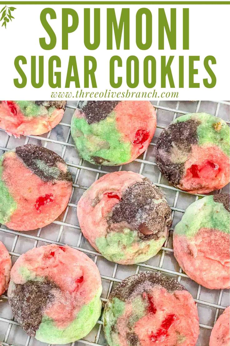 homemade sugar cookies with green, red and pink icing on a cooling rack in the background