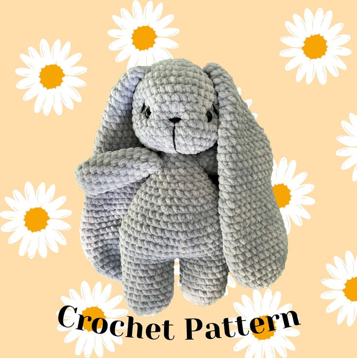 a crocheted stuffed animal sits in front of daisies with the words crochet pattern on it