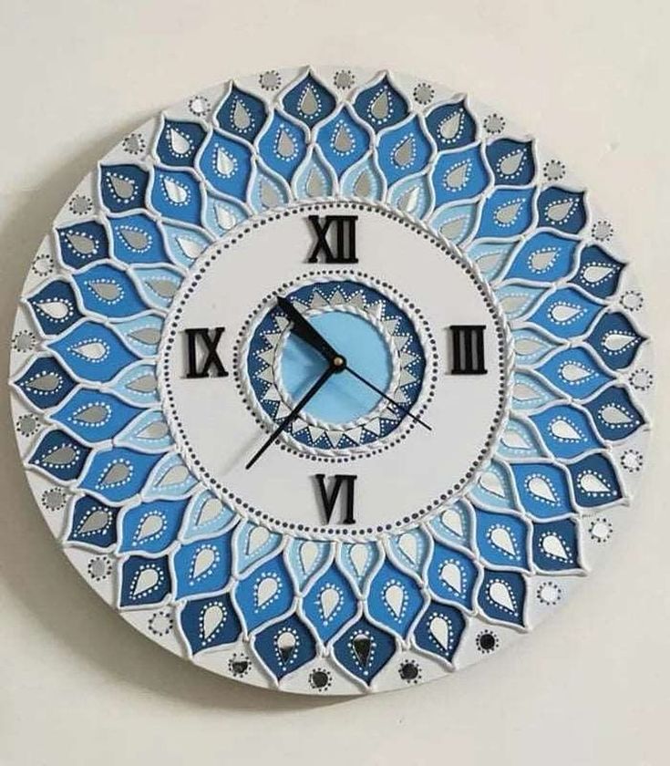 a blue and white clock with roman numerals in the middle on a wall