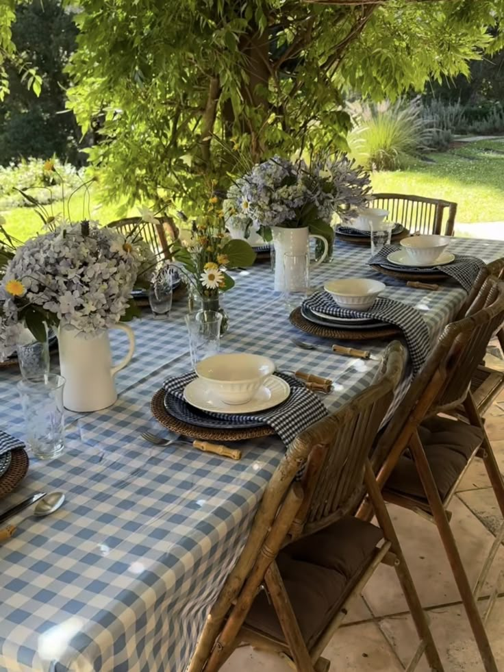 the table is set with plates and place settings