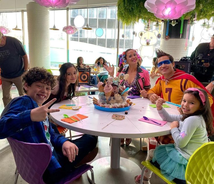 a group of kids sitting around a table