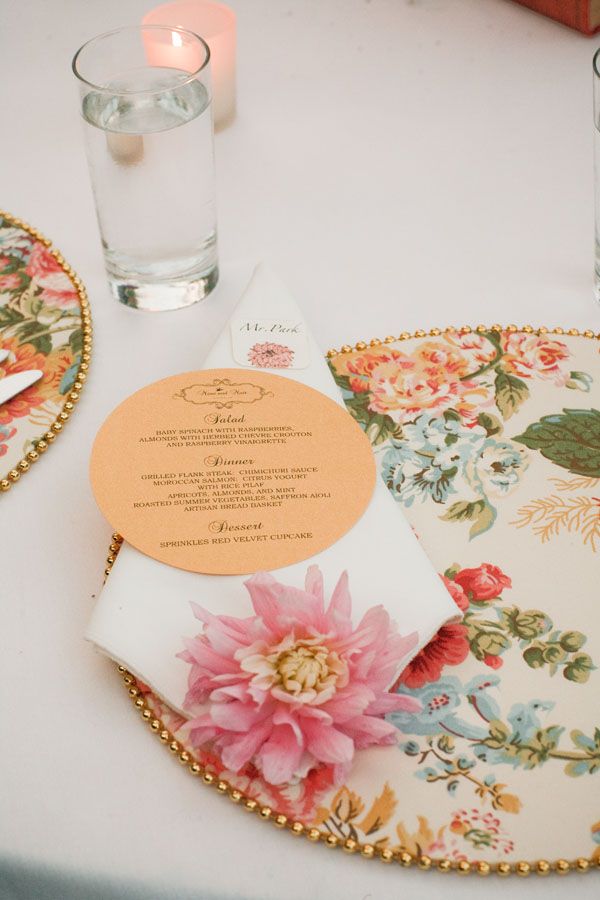 the table is set with flowers and place settings