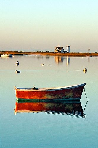 a small boat floating on top of a lake